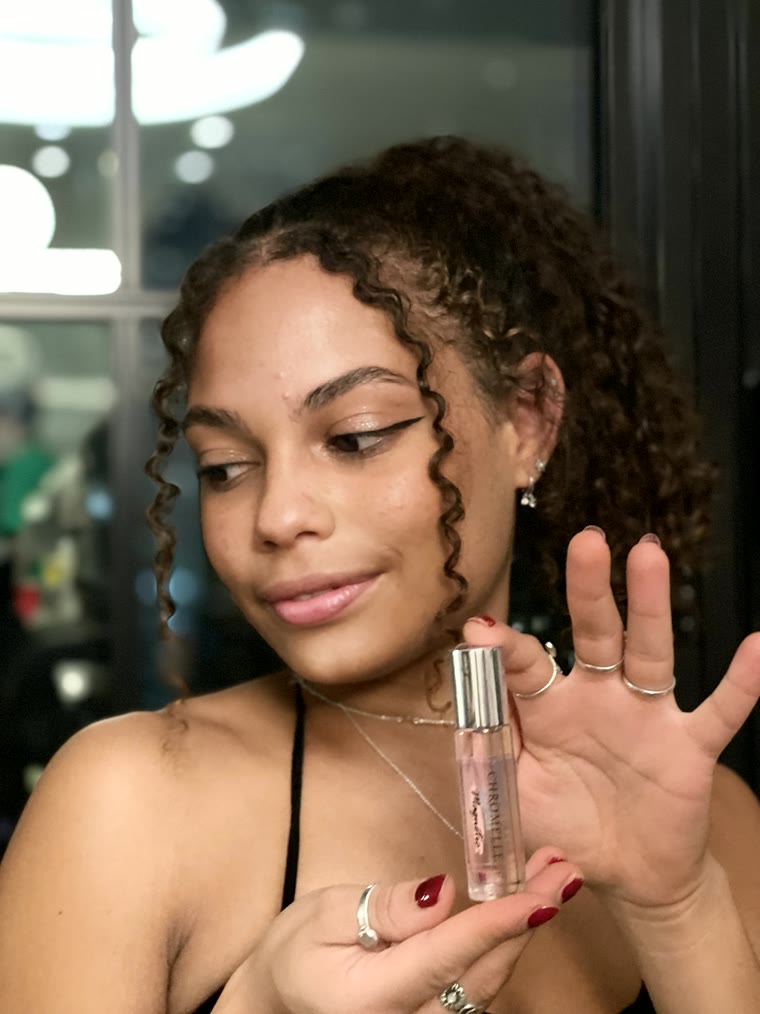 Woman holding a Chromelle Magnetic roll-on perfume oil